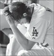  ?? Robert Gauthier Los Angeles Times ?? CLAYTON KERSHAW sits in the dugout after leaving the game in the seventh inning against the Mets.