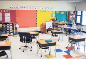  ?? Saul Flores / Hearst Connecticu­t Media ?? Sara Calechnan gets her classroom ready for students on Wednesday.