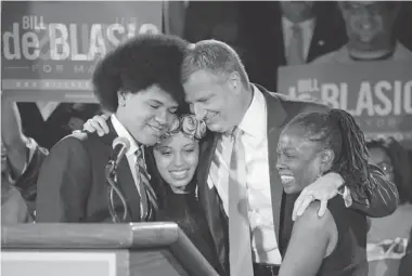  ?? ASSOCIATED PRESS FILES ?? New York Democratic mayoral candidate Bill de Blasio is shown with his son, Dante, left, daughter Chiara and wife Chirlane McCray at his election headquarte­rs after polls closed in the city’s primary election on Sept. 10. The election is Nov. 5.