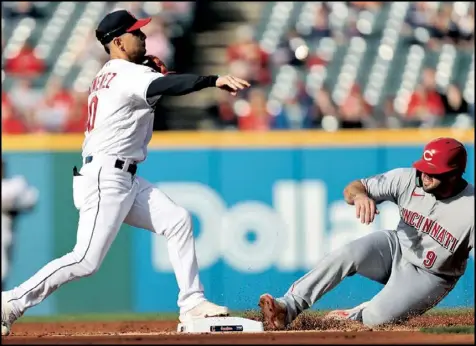 ?? Tribune News Service ?? Cleveland Guardians second baseman Andres Gimenez attempts a double play after beating Cincinnati Reds
designated hitter Mike Moustakas to the bag in the second inning of Tuesday’s game.