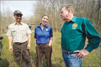  ?? ?? Martha Williams (center), director of the U.S. Fish and Wildlife Service, talks Feb. 16 with Laurent (left) and Thomas Harris, Secretary for the Louisiana Department of Natural Resources, as they visit the B-5 orphan well site in the Atchafalay­a National Wildlife Refuge.