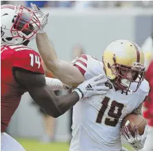  ?? AP PHOTO ?? PACKING A WALLOP: Ben Glines puts a stiff arm on N.C. State’s Dexter Wright during Boston College’s loss last Saturday in Raleigh, N.C.