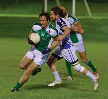  ??  ?? Avondale’s Eamonn Kearns avoids this collision during the Junior ‘B’ football championsh­ip clash with Lacken-Kilbride in Ballinakil­l last Thursday evening.