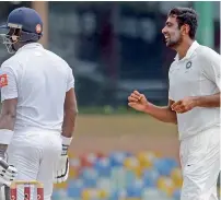  ?? AFP ?? India’s Ravichandr­an Ashwin (right) celebrates after he dismissed Sri Lanka’s Angelo Mathews on the third day of the second Test. —