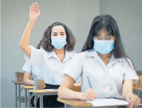  ??  ?? BACK TO CLASS: The number of pupils missing school because of the pandemic has fallen significan­tly but there is no room for complacenc­y.