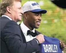  ?? Ronald Martinez/Getty Images ?? Saquon Barkley poses with NFL Commission­er Roger Goodell after being picked No. 2 overall by the New York Giants.