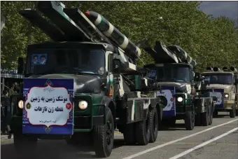  ?? THE ASSOCIATED PRESS ?? Missiles are carried on trucks during Army Day parade at a military base in northern Tehran, Iran, Wednesday, April 17, 2024. In the parade, President Ebrahim Raisi warned that the “tiniest invasion” by Israel would bring a “massive and harsh” response, as the region braces for potential Israeli retaliatio­n after Iran’s attack over the weekend. The banner on the truck reads in Farsi: “Surface-to-surface Nazeat precision missile.”