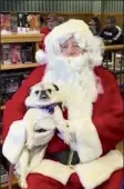  ?? Courtesy Be PAWSITIVE ?? Lola, a therapy pug with Be Pawsitive, visited with santa Claus in 2019.