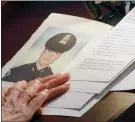  ?? The Associated Press ?? Pictured is U.S. Capitol Police officer Brian Sicknick, as an urn with his cremated remains lies in honour on a black-draped table at the centre of the Capitol Rotunda, Wednesday, in Washington.