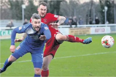  ?? Pic: Richard Birch ?? Bangor City’s Jamie Reed (blue) tussles with Llandudno’s Danny Hughes