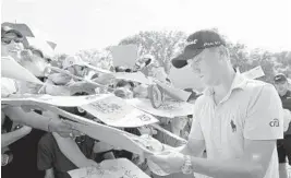  ?? STUART FRANKLIN/GETTY IMAGES ?? Justin Thomas signs autographs during his practice round Wednesday prior to the 2018 PGA Championsh­ip at Bellerive Country Club. Thomas has won five times in the past year while his friend Jordan Spieth has been shut out.