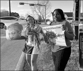  ?? JUAN LOZANO / ASSOCIATED PRESS ?? Shan’terrius Sly-brown, 16, left, and Shaniya Wade-red, 15, hold signs Feb. 21 during a protest outside of the home of Barbers Hill Independen­t School District superinten­dent Greg Poole in Baytown, Texas. The teenagers also attended a bench trial for Darryl George, a student who was punished over his hairstyle.