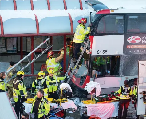  ?? WAYNE CUDDINGTON ?? First responders attend to victims of the rush-hour bus crash at the Westboro Station near Tunney’s Pasture Friday afternoon.