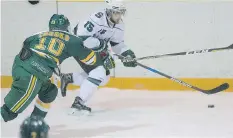  ?? KAYLE NEIS ?? Golden Bears forward Jamie Crooks fights for the puck with Huskies forward Michael Sofillas at Rutherford Rink on Friday.