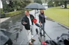  ?? PABLO MARTINEZ MONSIVAIS — THE ASSOCIATED PRESS ?? President Donald Trump and first lady Melania Trump walk across the South Lawn of the White House in Washington, Monday to board Marine One helicopter for a short trip to Andrews Air Force Base, Md., en route to Florida to tour areas the devastatio­n left behind from Hurricane Michael last week.