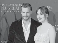  ?? Francois Mori / Associated Press ?? “Fifty Shades Freed” stars Jamie Dornan and Dakota Johnson are shown at the film’s world premiere in Paris last week.