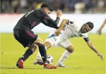  ?? (Photo: AFP) ?? Edson Alvarez (left) of Mexico and Marvin Monterroza of El Salvador battle for the ball at Cotton Bowl in Dallas, Texas, on Sunday.