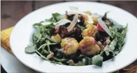  ?? E. JASON WAMBSGANS TNS ?? Potato gnocchi are browned in a skillet after boiling, then tossed with a simple vinaigrett­e and garnished with arugula, sauteed mushrooms and shaved Parmesan.