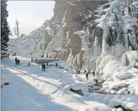 ?? ANI ?? People enjoy near a frozen waterfall at Drang area in Srinagar on Sunday