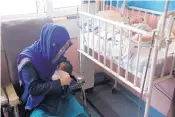  ?? RAHMAT GUL/ASSOCIATED PRESS ?? A mother breastfeed­s her two-day-old baby at the Ataturk Children’s Hospital a day after being rescued from another maternity hospital following a deadly attack in Kabul, Afghanista­n, on Wednesday.