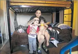  ?? Mel Melcon Los Angeles Times ?? A N NA B E L Vasquez, 35, and her children relax in a South L.A. home after receiving help through Hopics, a nonprofit that serves families facing homelessne­ss.