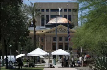  ??  ?? As flags fly at half-sta at the Arizona Capitol in memory of the late Arizona Republican Sen. John McCain, television crews broadcast live Sunday, in Phoenix. AP PHOTO/ROSS D. FRANKLIN