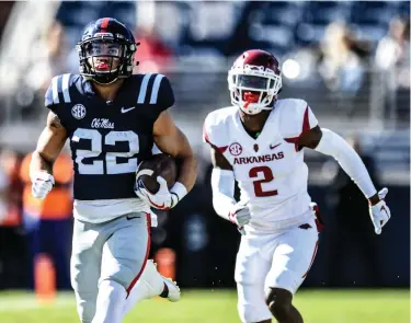  ?? Associated Press ?? Mississipp­i running back Jordan Wilkins (22) outruns Arkansas defensive back Kamren Curl (2) to score a touchdown during an NCAA college football game Saturday at Vaught-Hemingway Stadium in Oxford, Miss.