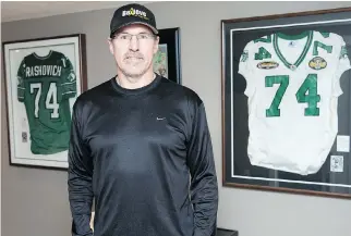  ??  ?? The walls of Dan Rashovich’s basement in his Regina home are adorned with his framed Grey Cup jerseys.