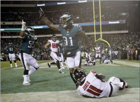  ?? MATT ROURKE - THE ASSOCIATED PRESS ?? The Philadelph­ia Eagles’ Jalen Mills (31) and Brandon Graham (55) celebrate after the Falcons’ Julio Jones (11) cannot catch a fourth down pass during the second half of an NFL divisional playoff football game, Saturday, in Philadelph­ia. The Eagles won...