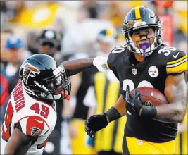  ?? Charles Leclaire ?? USA Today Steelers running back James Conner pulls away from Falcons safety Deron Washington in the fourth quarter of Pittsburgh’s 17-13 preseason win Sunday at Heinz Field.