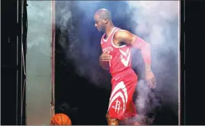  ?? MICHAEL WYKE / AP ?? Houston Rockets’ Chris Paul navigates through artificial fog as he takes part in a promotiona­l video shoot during NBA media day in Houston on Monday.