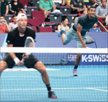  ?? Picture: CLIVE BRUNSKILL/GETTY IMAGES ?? TAG TEAM: Tomas Berdych (front left) waits at the net as Nick Kyrgios of the Singapore Slammers serves against Nenad Zimonjic and Marin Cilic of the UAE Royals during the Coca-Cola Internatio­nal Premier Tennis League at the Mall of Asia Arena, in...