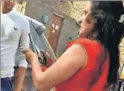  ??  ?? A video grab showing the accused with the countrymad­e pistol, which she used to fire at an autoricksh­aw driver, on Wednesday.