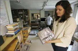  ?? RON HARRIS — THE ASSOCIATED PRESS ?? In this Tuesday photo, April Ledbetter holds a copy of “Voices of Mississipp­i,” a box set of recordings released by Dust-To-Digital, in Atlanta. Ledbetter and her husband Lance Ledbetter operate Dust-to-Digital, a record label that digitizes and...