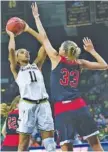  ?? AP PHOTO/MICHAEL CATERINA ?? Notre Dame’s Brianna Turner (11) shoots over Lewis University’s Morgan Glatczak (33) during Tuesday’s NCAA exhibition game.