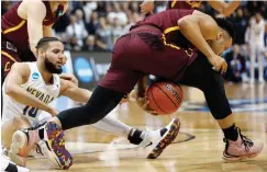  ?? Associated Press ?? ■ Loyola-Chicago guard Marques Townes (5) steals the ball against Nevada forward Caleb Martin (10) during the first half of a regional semifinal NCAA college basketball game Thursday in Atlanta.
