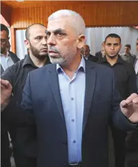  ?? (Mohammed Salem/Reuters) ?? HAMAS CHIEF Yahya Sinwar addresses the media before meeting with the chairman of the Palestinia­n Central Election Committee, Hana Naser, in Gaza City last month.