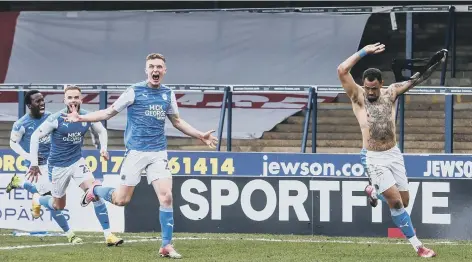  ??  ?? Jonson Clarke-Harris (right) celebrates the goal that sealed promotion for Posh last season. Photo: Joe Dent/theposh.com.