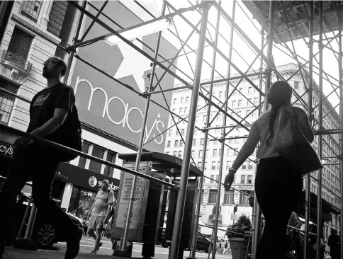  ?? — WP-Bloomberg photo ?? Pedestrian­s walk outside of a Macy’s store in New York on Aug 11, 2016.