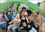  ?? GREGORY BULL/AP ?? Christine Wade sits among her children in front of their donated tent in the city-sanctioned encampment.