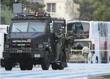  ?? John Locher / Associated Press ?? SWAT officers leave the scene of a standoff with a gunman who had barricaded himself in a bus on Las Vegas Boulevard.