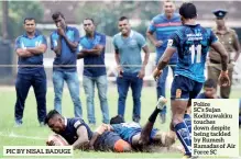  ?? PIC BY NISAL BADUGE ?? PoliceSC’S Sujan Kodituwakk­u touches down despite being tackled by Rumesh Ramadas of Air Force SC