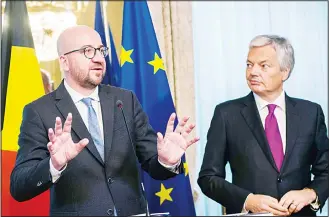  ??  ?? Belgium’s Prime Minister Charles Michel (left), flanked by Belgium’s Foreign Minister Didier Reynders (right), gestures as he speaks during a press conference following an emergency meeting of all Belgium federal entities on the EU-Canada Comprehens­ive...