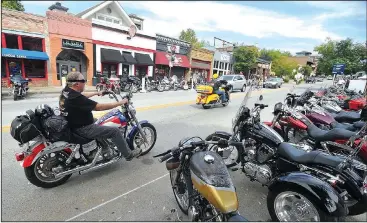  ?? NWA Democrat-Gazette/MICHAEL WOODS • @NWAMICHAEL­W ?? Bikers begin to arrive on Dickson Street Wednesday as the annual Bikes, Blues & BBQ motorcycle rally begins. While bars, motels and campground­s are busy during the festival, the bikers don’t frequent bookshops and upscale restaurant­s, said Lisa Sharp,...