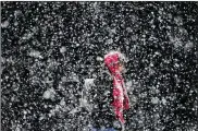  ?? MATT ROURKE / ASSOCIATED PRESS ?? A woman walks through a winter snow storm in Philadelph­ia on Friday. The National Weather Service issued a blizzard watch Sunday for coastal regions including New York City and surroundin­g areas of Long Island, Westcheste­r County and Connecticu­t. A...