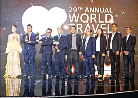  ?? WORLD TRAVEL AWARDS ?? The Cambodian delegation shows off the two World Travel Awards given to the Kingdom, in the categories of Asia’s Leading Cultural Destinatio­n and Asia’s Leading Youth Travel Destinatio­n, at the Internatio­nal Travel Expo Ho Chi Minh City 2022 on September 7.