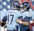  ?? AP file photo ?? Titans quarterbac­ks Marcus Mariota and Ryan Tannehill hug before Tennessee’s 35-32 win over Kansas City on Nov. 10.