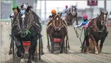  ?? PHILIP FONG / AFP ?? Horses compete at a Banei Keiba race at the Obihiro racecourse in Obihiro, Hokkaido Prefecture, Japan, on Dec 9.