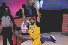  ?? ASSOCIATED PRESS ?? LOS ANGELES LAKERS’ ANTHONY DAVIS (3) reaches for the ball as Houston Rockets’ James Harden defends during the second half of an NBA conference semifinal playoff game on Thursday in Lake Buena Vista, Fla.