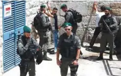  ?? — AFP ?? JERUSALEM: Israeli border guards frisk Palestinia­n men outside Damascus Gate in Jerusalem’s Old City yesterday.